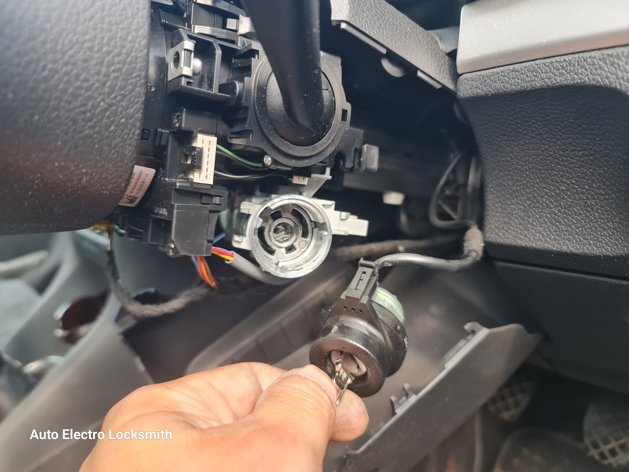Auto Electro Locksmith working on a customer's vehicle on-site